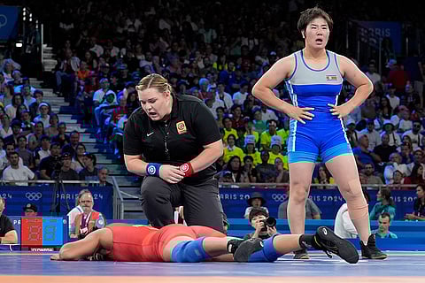 Nisha Dahiya reacts after the women's freestyle 68kg wrestling quarterfinal match